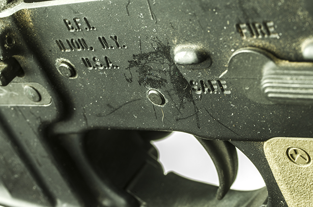 Formerly located in Maine, Bushmaster rifles are now produced in New York. A close shot of an AR-15 rifle's trigger.