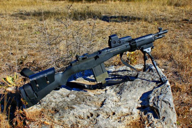 A M1a rifle resting on a bipod.